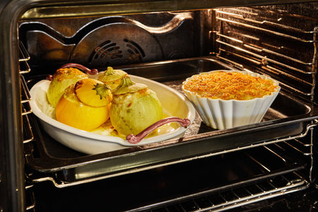 Stuffed zucchini and pie are baked in an electric ovenの写真素材