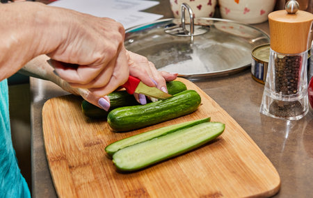 Chef prepares the cucumbers for stuffing and baking.の写真素材