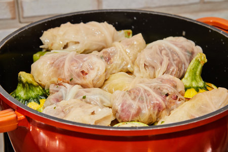 Stuffed cabbage rolls and stuffed zucchini are cooked in saucepan on gas stove.の写真素材