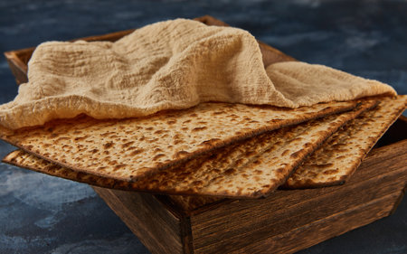 Passover celebration concept - Jewish holiday Passover. A stack of matzos on blue marble with a beautiful composition in a wooden box.の写真素材