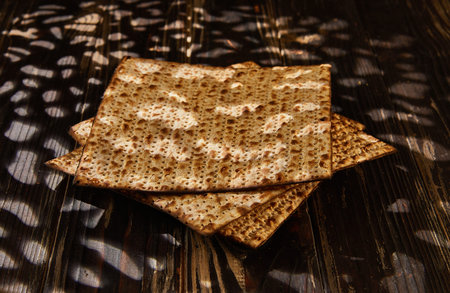 Passover celebration concept - Jewish holiday Passover. Stack of matzo on a wooden background with a...