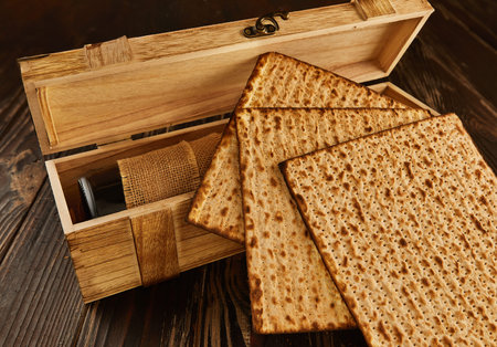 Passover celebration concept - Jewish holiday Passover. Stack of matzo on a wooden background with a...