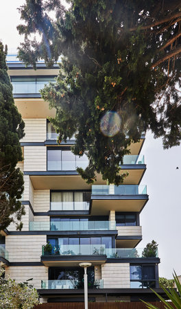 Luxurious house with balconies on boulevard near the sea with green spaces.の写真素材
