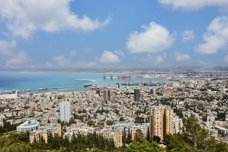 Seaport in the city of Haifa, panorama of the port and city buildings against the background of a blue sky with clouds.の写真素材
