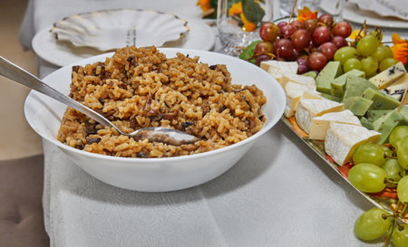 Close-up of a spoon serving delicious mushroom risotto in a kitchen, highlighting the creamy texture and hearty ingredients.の写真素材