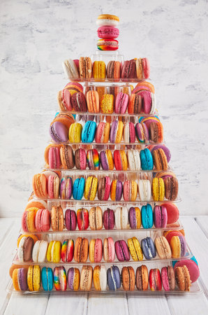 A tall, multi-tiered macaron tower with vibrant pastel colors, ideal for elegant parties and special celebrations.の写真素材