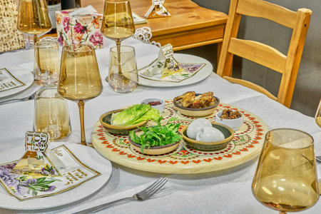 Close-up of the Passover seder plate showcasing symbolic foods like eggs, herbs, and lamb shank on an ornate decorated dish.の写真素材