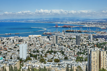 Panoramic view of Haifa, Israel from Mount Carmel, showcasing urban density, coastline, and Haifa Port under sunny skiesの写真素材