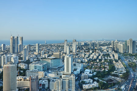 Tel Aviv, Israel - November 19, 2025: A broad panoramic view of a city by the sea with numerous...