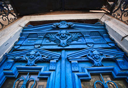 Blue faces in the door of the old house in Odessaの写真素材