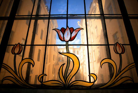 Old stained glass window with red flowersの写真素材