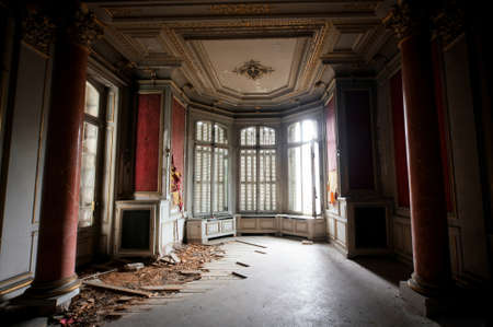 COLMAR, FRANCE -JAN 10,2015:  Abandoned mansion Lumiere. House was built in the early 1900s by Swiss tobacco tycoon. Now abandoned. It is a very beautiful building with stunning interiors, fireplaces etc. Red hall with columnsのeditorial素材