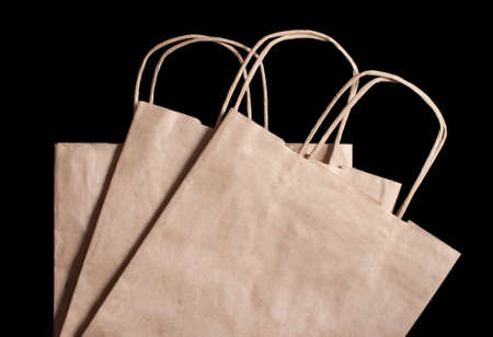 3 paper brown bags on a black background. View from aboveの写真素材