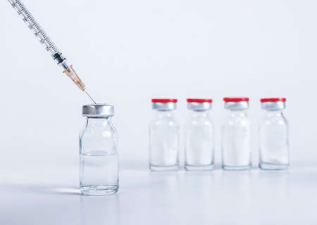 syringe picks up medicine for injection from a vialの写真素材
