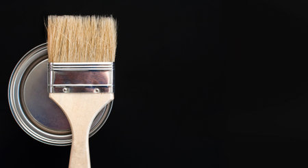 paint brush and metal can of paint on a black background. Copy space. View from aboveの写真素材