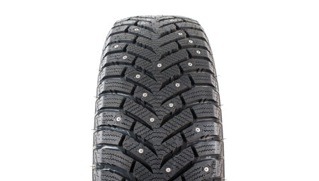 Four new winter car tires with spikes on a white background. Isolated