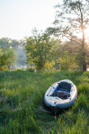 Kayak on the river bank in summer at sunset in the eveningの写真素材