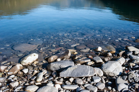 Stones on the shore of a mountain lakeの写真素材
