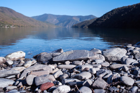 Stones on the shore of a mountain lakeの写真素材