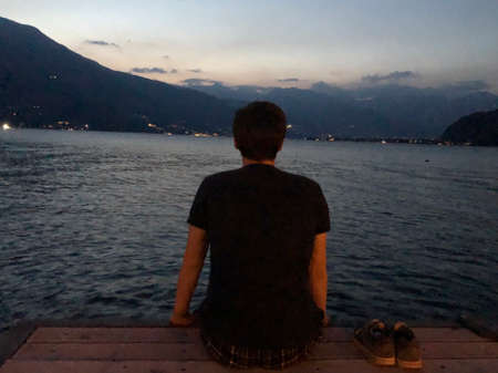 Man sitting on the pierの写真素材