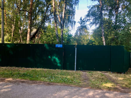Fence in public forest. How some people can restrict access to nature for other peopleの写真素材