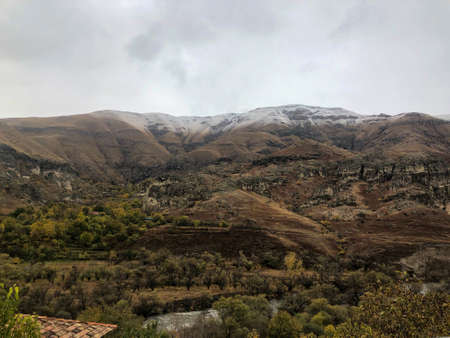 A remote place where the ancient city of Vardzia is located. Mountains turn into desert, and tops of sandy mountains are covered with snowの写真素材