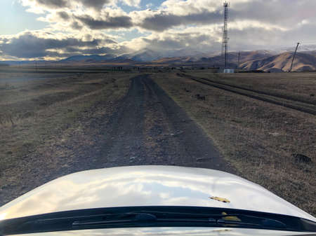 Mountain road. Travel on a deserted road in the clouds. even in such remote places people live. They are engaged in subsistence farming and practically do not use the modern benefits of civilizationの写真素材