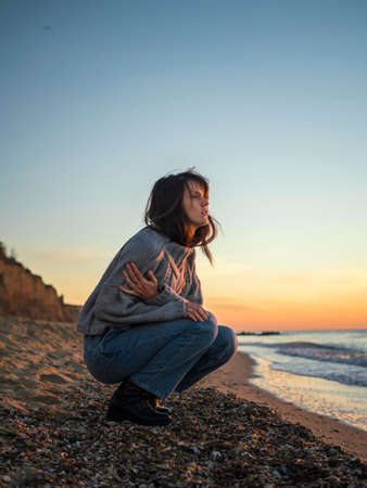 Young woman on the beach against the backdrop of the seascape.の写真素材