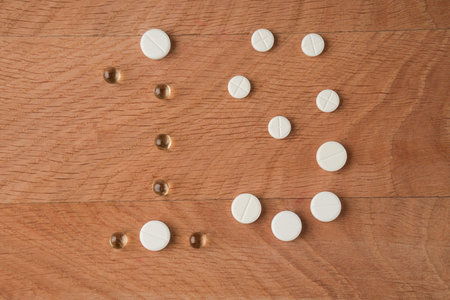 Number nineteen laid out from tablets of various shapes on a wooden board