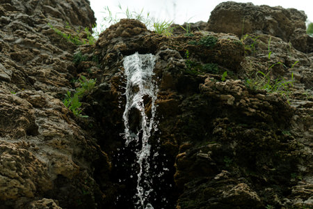 A waterfall, a drop of water that originates from rockの写真素材