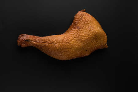 Appetizing smoked chicken legs, Ice, on a black background in isolation poultry meat, chicken smoked meatの写真素材