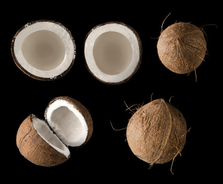 Coconut divided into two equal parts, view from the top, on a black background in isolation, collage