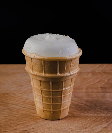 ice cream in a waffle cup on a wooden board on a scribble background isolatedの写真素材