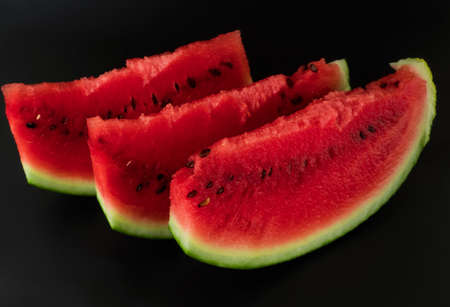 Three skibki ripe watermelon on a black backgroundの写真素材