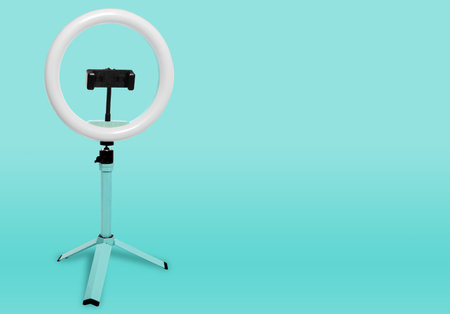 Selfie ring lamp with tripod on a blue background