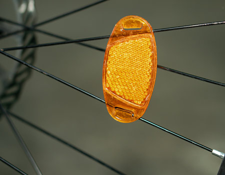 A reflector attached to the spokes of a bicycle wheel.の写真素材