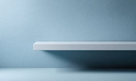 White shelf positioned against a calming blue wall, providing a clean and modern aesthetic, perfect for showcasing items or artwork with ample copy space for textの素材