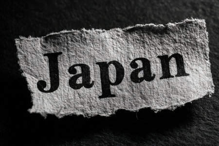 Torn paper featuring the word Japan against a dark backdrop, highlighting artistic elements and cultural themes in a visually striking mannerの素材