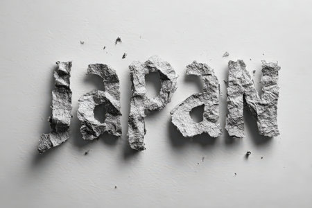 Artistic representation of the word Japan, made from crumpled gray paper, showcasing texture and creativity in a minimalist design with cultural significanceの素材