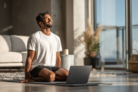 Man engaged in mindfulness meditation on a yoga mat in a spacious, well-lit living room, surrounded by plants and a calming atmosphere for relaxationの素材