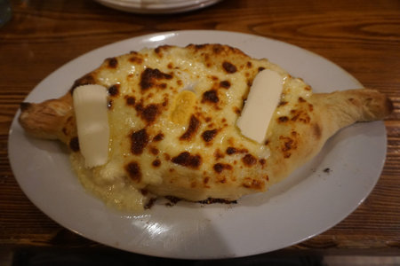 Georgian Traditional Khachapuri Ajaruli with Egg and Butter on a Plate
