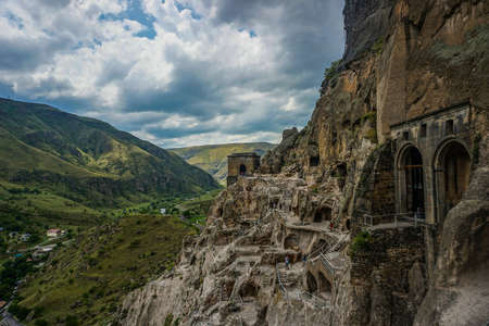 Vardzie Caves Settlement Panoramic View of the Landscape with Rainy Cloudsの写真素材