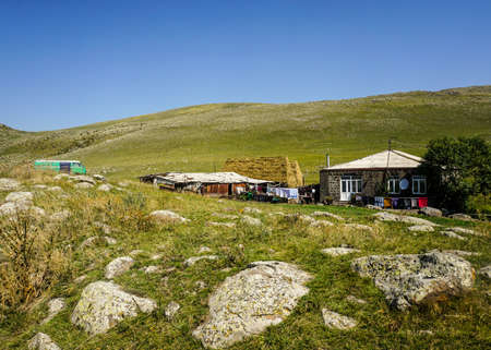 Lake Arpi Village House with Rocks Grass Land in Summer and Blue Skyのeditorial素材