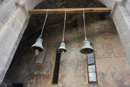 Vardzia Cave Three Church Bells Hanging on a Woodの写真素材