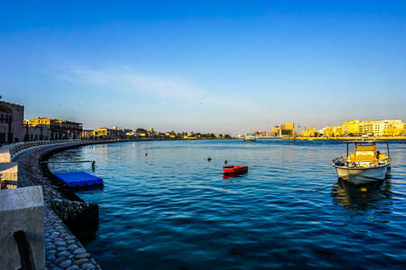 Dubai Heritage Village View at the Background with Anchored Boats at the Creekの写真素材