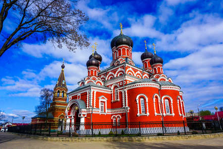 Barysaw Red Colored Holy Resurrection Cathedral Side View with Clouds and Blue Sky Backgroundの写真素材