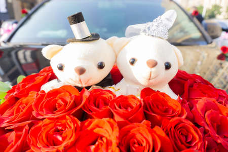 Wedding Heart Shaped Artificial Red Rose Flower Decoration with Two Teddy Bears on a Carの写真素材