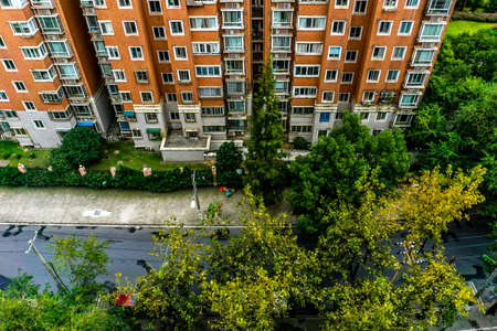 Shanghai Multi Level Highrise Apartment Building Upside Down View with Road Treesの写真素材