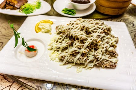 Chinese Deep Fried Pork Cutlet on a White Plate