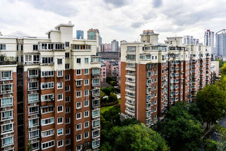 Shanghai Multi Level Highrise Apartment Building with Cloudy Rainy Sky Backgroundの写真素材